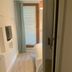 Self Contained Rooms in Central Torquay bedroom with light wood floor and glass door to a small balcony