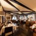 Tanneck in Bad Woerishofen dining room with set tables, leather banquette seating and arched windows