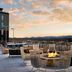 Rooftop terrace with fire pit at Moxy Asheville Downtown, Asheville, overlooking mountain sunset
