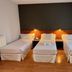 Shs Hotel Aeropuerto Madrid triple room with three single beds and bedside lamps
