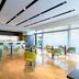 Hilton Garden Inn Venice Mestre San Giuliano lobby bar with green chairs and floor-to-ceiling windows in Venice