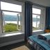Bryn Melyn Apartments in Barmouth bedroom with open windows and sea views