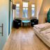 Gästehaus Seewarte Flensburg room with twin bed, two chairs and table by large windows