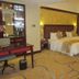 Golden Ray International Hotel in Yichang guest room with king bed, desk and patterned carpet