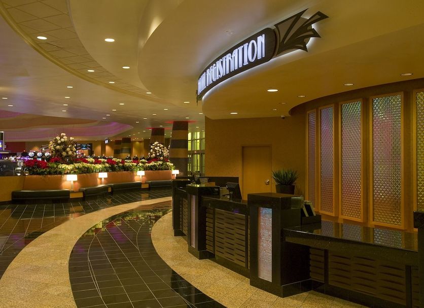 Bally's Quad Cities Casino & Hotel lobby entrance in Rock Island with curved front desk and flower display