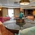 Comfort Suites Texarkana lobby with round glass table, patterned chairs and seating area