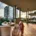 Il Mondo Boutique Hotel Brisbane balcony with table, chairs and city sunset view