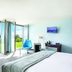 Starling Hotel Lausanne room with open doors to a green lawn and lake view in Saint-Sulpice