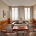 Meliá Paris Vendôme room with fireplace, large windows and seating area in Paris