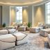 The Ritz-Carlton Orlando Grande Lakes lounge with beige seating, tall windows and potted plants in Orlando.