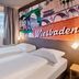 B&b Hotel Wiesbaden-Ost guest room with twin beds and Wiesbaden wall mural