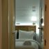diezmadrid hotel room in Madrid with a neatly made bed, folded towels, and a bedside lamp