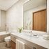 Oakwood Residence Saigon bathroom with bathtub, vanity, mirror and toilet in Ho Chi Minh City