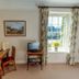 Manor Farm B&B in Marlborough room with desk, TV, and window view with flowers