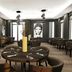 Parkhotel Horst dining room in Horst with dark tables, upholstered chairs and black-and-white wall art