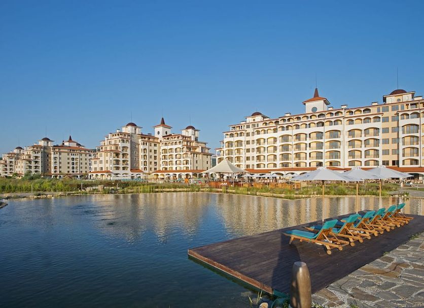 Sunrise All Suites Resort in Obzor with a lagoon and beachfront resort buildings under blue sky