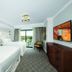 Disney's Riviera Resort room in Lake Buena Vista with two beds, balcony view, and colorful wall art