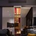 QT Sydney lounge with two armchairs and a lit glass display cabinet in Sydney