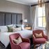 Rookery Hall Hotel & Spa in Nantwich guest room with king bed, pink chairs and garden-view windows