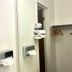 Bridgewater Hotel in Bridgewater bathroom with stacked towels, tissue dispenser, and wall hooks