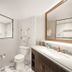 Disney's Riviera Resort bathroom in Lake Buena Vista with marble-look tile, walk-in shower, vanity, and toilet