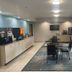 Days Inn by Wyndham Jefferson City breakfast area with tables, chairs, coffee station and TV
