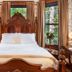 1899 Wright Inn & Carriage House in Asheville bedroom with carved wood bed and bay windows