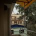 Sudha's Garden Home in Kathmandu balcony view with trees, nearby buildings, and an awning