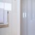 Studio's De Vlijt Texel bathroom with a glass shower enclosure in De Cocksdorp