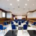 Grand Hotel Salerno meeting room with rows of blue chairs and a large presentation space in Salerno