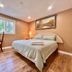 Cozy Home Near Transit & Hillcrest Mall in Richmond Hill guest room with bed, TV, desk, and window