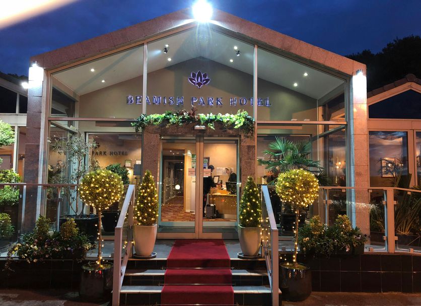 Beamish Park Hotel in Newcastle upon Tyne entrance with red carpet, glass doors and lit planters