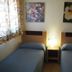Águilas de los Collados in Águilas guest room with two single beds and bedside lamp