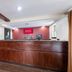 Red Roof Inn & Suites Stafford, VA - Quantico lobby reception desk in Stafford with wood counter and red wall