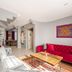 Bright Apart Hotel Istanbul apartment-style living room with sofa, red couch, coffee table and bright windows