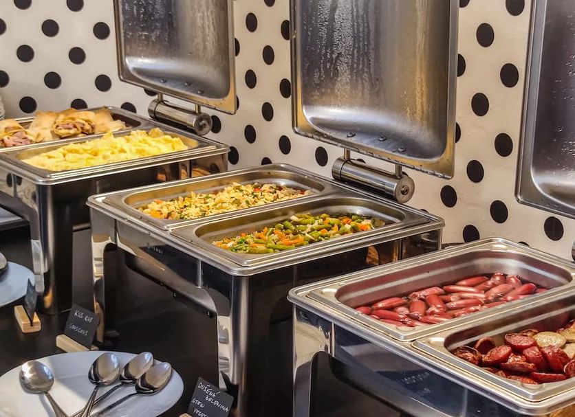 Breakfast buffet at Lh Vintage Design Hotel Sax in Prague with hot trays of eggs, vegetables, and sausages