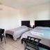 Hotel Cascada, Cuautla: simple twin room with two beds, desk, chair, and air conditioner
