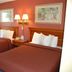 Gulf Towers Resort Motel in Indian Rocks Beach guest room with two beds and wall lamps