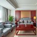 Fuxing Oriental Boutique Hotel in Chifeng living room with gray sofas, red coffee table and lamp