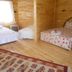 Fire pansiyon, Cirali: wooden guest room with three beds and floral bedspread