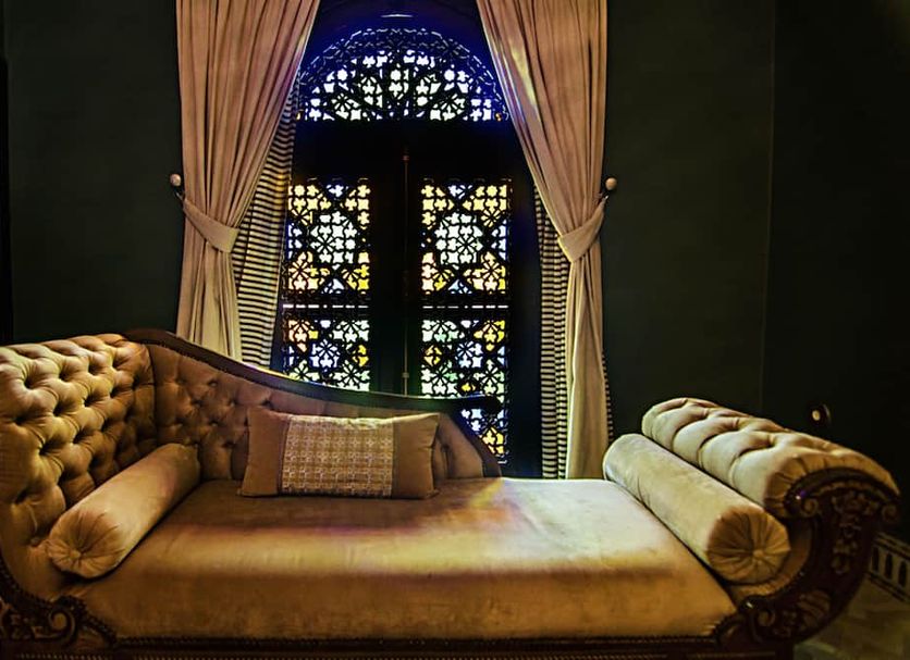 Palais Ommeyad Suites & Spa, Fez: ornate tufted chaise lounge beside stained-glass window