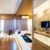 Tamsabai Hotel, Nakhon Sawan: modern guest room with twin beds, wall-mounted TVs, and curtain-covered window