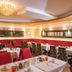 Hotel Jägerhof Mayrhofen dining room with red banquette seating and set tables
