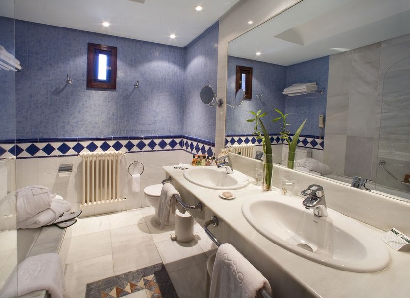 Bathroom at Parador de Jarandilla de la Vera in Jarandilla de la Vera with twin sinks and tiled walls