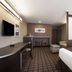 Microtel Inn & Suites by Wyndham Kenedy/Karnes City room with king bed, desk and sitting area