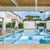 Resort Miramonti, Forte dei Marmi: outdoor pool with lounge chairs and a glass vase of citrus fruit