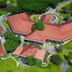 Aerial view of The Suites At Mount Malarayat in Lipa City with red-roofed buildings and lush grounds
