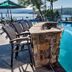 The Lodges at Cresthaven in Lake George: lakeside pool with stone fire pit, lounge chairs, and lake view