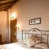 Hotel Naranjo De Bulnes in Las Arenas guest room with wrought-iron bed, wooden furniture and sloped ceiling