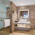 Novotel Zhengzhou Convention Centre bathroom with walk-in shower, vanity, mirror and toilet in Zhengzhou